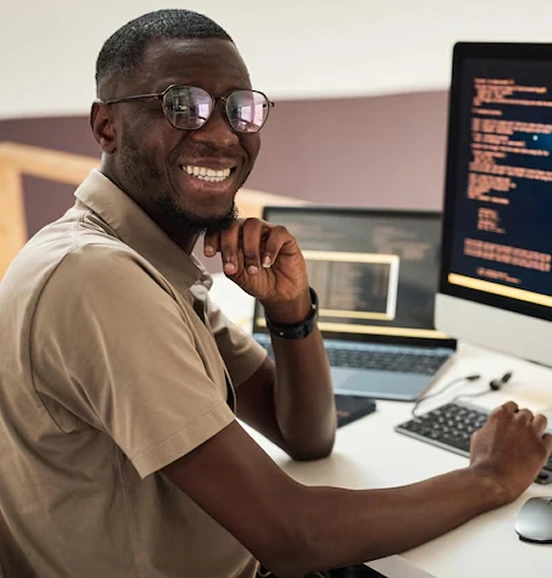 Smiling guy pressing laptop